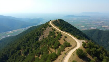 Fototapeta premium A winding road through the mountains leading to the horizon