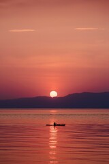 Sunset kayaking on tranquil lake
