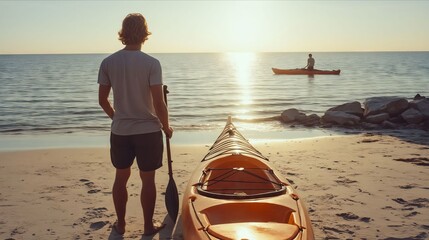 A man standing next to a kayak on a beach at sunset