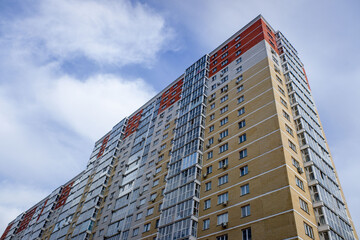 A tall building with a red and yellow facade