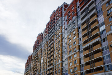 A row of brown and red buildings with windows and balconies