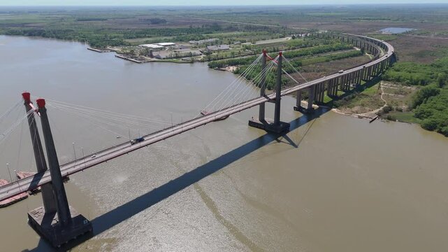 Drone view of Justo Jose de urquiza bridge above the wide Parana Guazu river, a vast waterway, Buenos Aires Argentina. Moving to the left