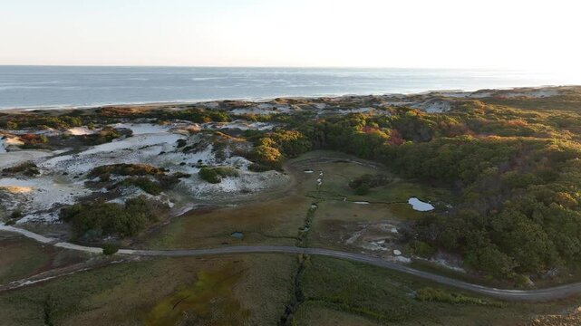 Cape cod sand dunes and salt marsh at sunrise in barnstable, massachusetts, aerial view