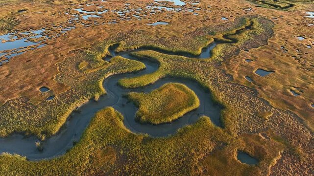 A winding salt marsh at sunrise in cape cod, barnstable massachusetts, aerial view