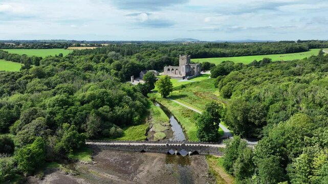 Ireland Epic Locations drone flying slowly over bridge to romantic Tintern Abbey Saltmills Wexford Ireland in summer