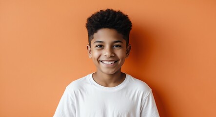mixed race teen boy orange background wearing plain white tshirt smiling happy portrait