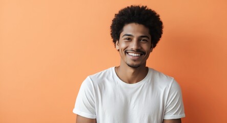 mixed race young man orange background wearing plain white tshirt smiling happy portrait
