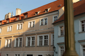 A charming row of buildings, each featuring a vibrant red roof complemented by pristine white windows, stands in a picturesque setting