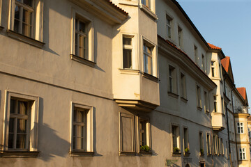 A large building that features an abundance of windows along with a bright red roof that adds to its charm and character