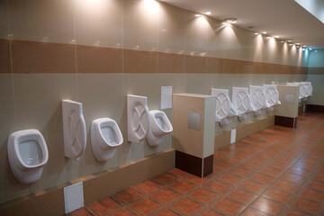 Big clean public toilet with white urinals