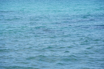 Sea water surface, wave texture. Calm seascape. The background of the blue waters of the sea. Background sea calm water