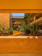 Building with vegetation on balconies, architectural photography.