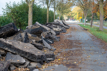 Road construction in Germany. Crushed concrete blocks of the old street on a country road.