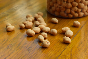 Closeup photo of some dried atomic Nuts and food storage or jar on wooden table