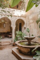 A courtyard with a fountain and a bench. There are two benches, one on the left and one on the right