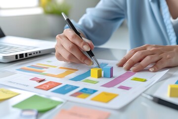 A businesswoman analyzes data on a graph using a pen, highlighting key areas with sticky notes.