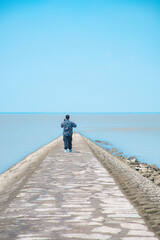 Hengsha Island, Shanghai - young man standing on the beach under the blue sky