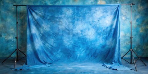 A blue photographic backdrop stretched taut on a studio stand, ready for a photo shoot.