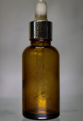 Cosmetic product, serum or skin care oil, glass amber bottle with dropper. Organic skin care, natural oils, herbal oil.