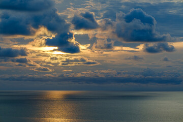 Romantic colorful sunset at the sea. View of Beautiful glorious golden sunset and golden hour above the sea in evening.