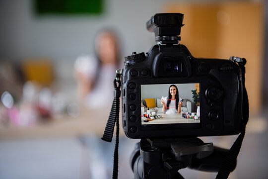 Photo of lovely young girl camera recording blurred background blogger tutorial video streaming beauty blog cosmetics home interior