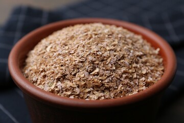 Buckwheat bran in bowl on table, closeup