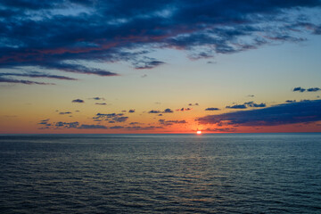 Romantic colorful sunset at the sea. View of Beautiful glorious golden sunset and golden hour above the sea in evening.