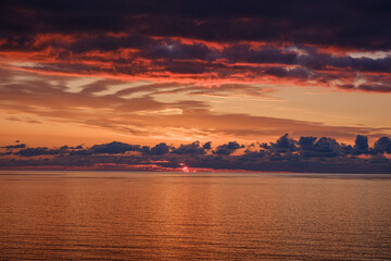 Romantic colorful sunset at the sea. View of Beautiful glorious golden sunset and golden hour above the sea in evening.