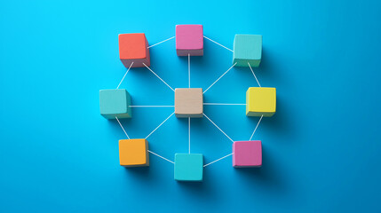 Obraz premium Colorful wooden blocks connected in circle by strings on blue background