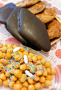 Italian christmas desserts, struffoli and chocolate covered mostaccioli cookies