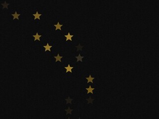 a dark background with a scattering of gold stars in the upper left corner.