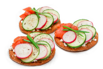Crispy Cracker Sandwiches with Salmon, Cucumber, Radish, Cottage Cheese and Green Onions - Isolated on White. Easy Breakfast. Quick and Healthy Sandwiches. Crispbread with Tasty Filling - Isolation