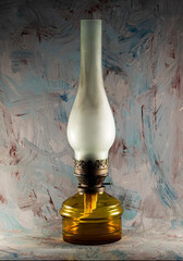 Old kerosene lamp on a dark abstract background.