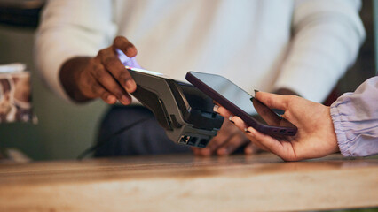 Close-up of contactless payment being made at new store launch, highlighting modern technology and business transactions. First customer. Concept of business, achievement, success, entrepreneurship