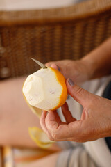 Holding an orange cut into two pieces