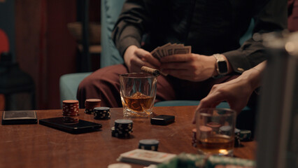 Two Caucasian poker players playing cards game blackjack woman female girl girlfriend play competition man male guy boyfriend date tournament gambling casino betting drink smoking cigar party at home