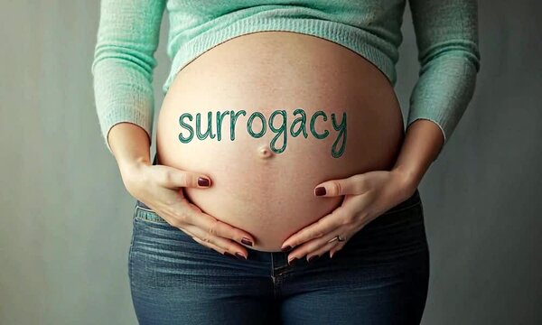 Pregnant belly with the written word "Surrogacy"