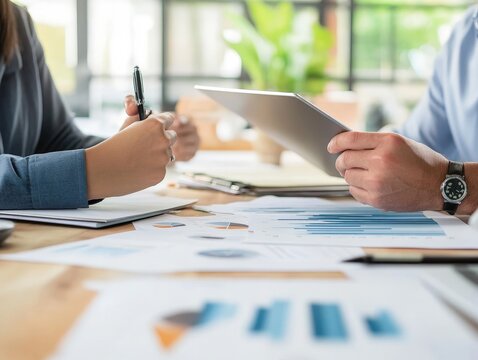 A business manager hosting a client meeting, discussing project timelines, deliverables, and expectations in a professional setting.