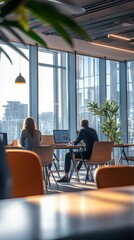 Business people working on computers in modern sunny open plan office
