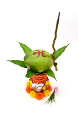 TOP VIEW OF PUJA MANGAL GHAT WITH GREEN COCONUT AND FRESH MARIGOLD FLOWER ON ISOLATED WHITE BACKGROUND.