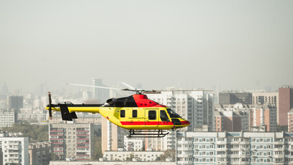 Air medical helicopter ambulance service in front of the cityscape grey sky