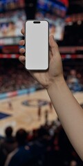 Caucasian White young male using smartphone with a blank white screen. Basketball game, sports arena, crowd apps mockup. Vertical phone orientation