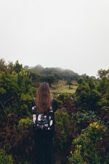 Woman with Backpack in a Misty Forest