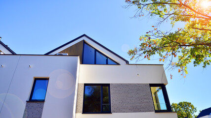 Harmony with nature, eco architecture. Terraced single family homes in newly developed housing estate. The real estate market in the suburbs with lush greenery surrounding. 