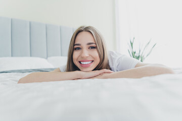 Photo of pretty cheerful lady dressed sleepwear smiling relaxing bed indoors room home house