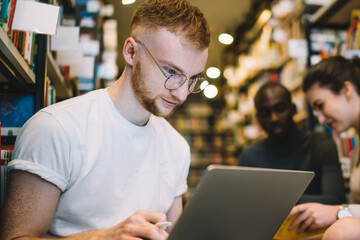 Student with friends searching for information in library