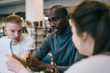 Group of students cooperating and preparing for exam together
