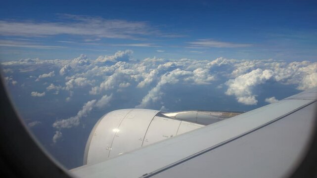 Beautiful blue sunny cloudscape view in stratosphere from an airplane window