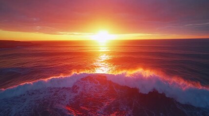 Fototapeta premium A vibrant sunset over a crashing wave in the ocean.