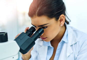Fototapeta premium Research, woman and scientist with microscope in lab for medical study. Healthcare, science and female doctor with scope equipment for sample analysis, particle testing and laboratory experiment.